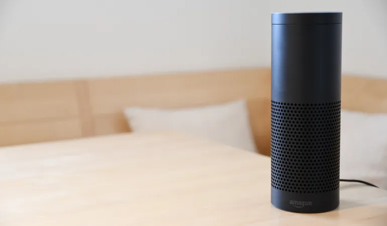An Echo Plus (Alexa speaker) on a table.